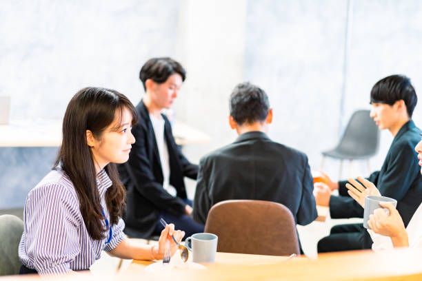 istock Office workers having lunch at a company cafeteria 1358558220
