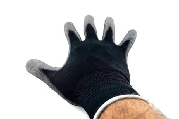 istock Black work glove on a mans open palm covered with latex on the inside, isolated on a white background, upper palm visible. 1358558564