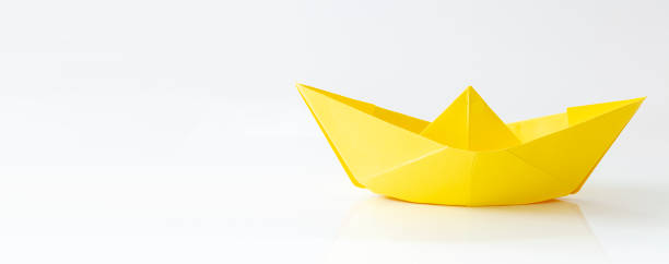 istock Yellow Paper boat isolated on white background with copy space, banner 1358560211