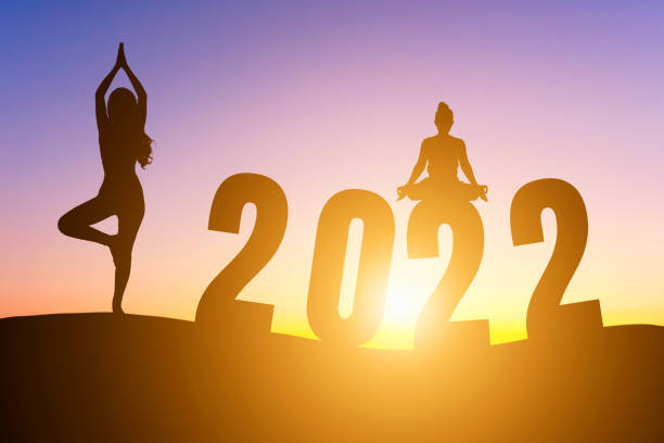с новым годом номера 2022, силуэт женщины, практикующей йогу ранним утром восход солнца над горизонтом фон, здоровье и концепция счастливого � - yoga challenge for 3 стоковые фото и изображ�ения