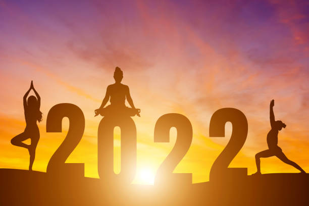 с новым годом номера 2022, силуэт женщины, практикующей йогу ранним утром восход солнца над горизонтом фон, здоровье и концепция счастливого � - yoga challenge for 3 стоковые фото и изображения