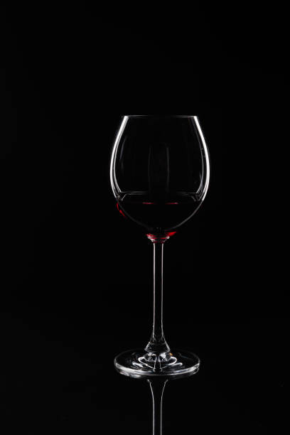 istock Glass of red wine at black background 1358562757