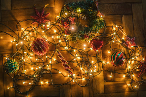 Woman's hands with lighting garland and toys for Christmas tree. BMPCC 6k Pro.