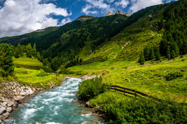 istock Clear Mountain River Flows Through Alpine Valley With Pine Forests In Deferegental In Tirol In Austria 1358565158