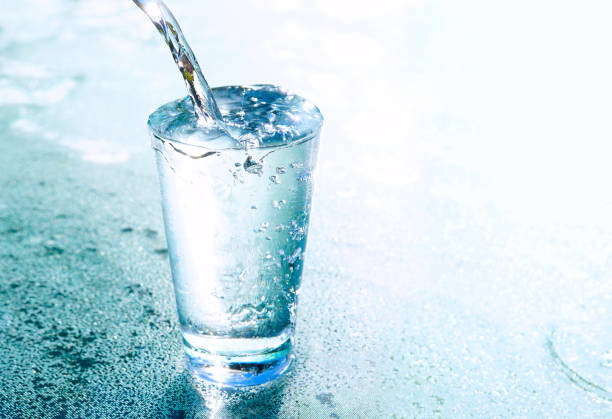 istock A stream of transparent cold water is poured into a glass beaker. 1358567774
