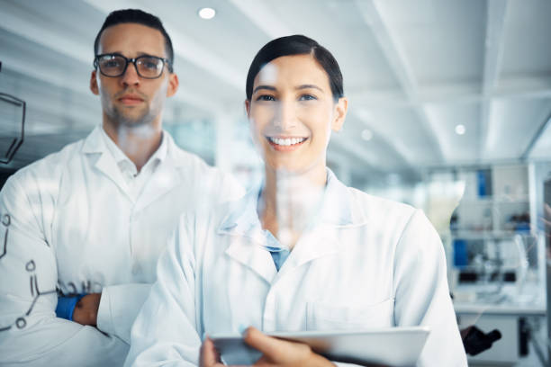 istock Shot two a young scientists solving equations on a glass screen in a laboratory 1358567989