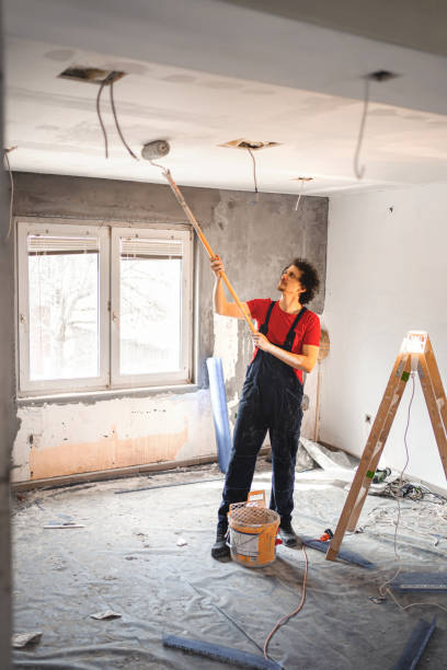 istock Construction worker painting apartment walls 1358574639