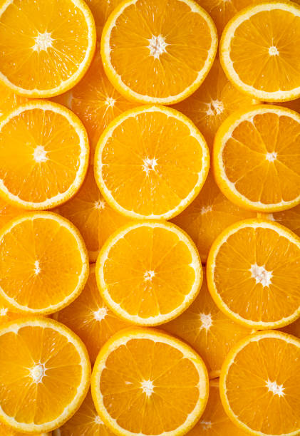istock Orange fruit slices citrus arrangement in a row full frame backg 1358574655