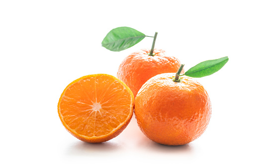 Fresh Oranges with Oranges slices on wooden Basket, Grapefruit or Cara Cara orange with leaves in Wooden background.