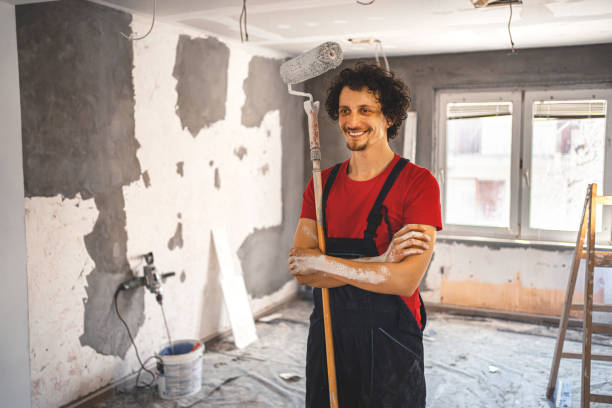 istock Construction worker painting apartment walls 1358574773