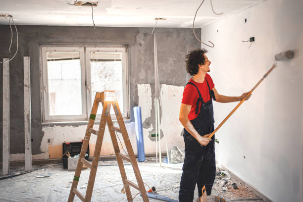 istock Construction worker painting apartment walls 1358574798