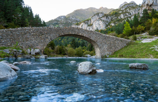 San Nicolas romanesque bridge over Ara river in Bujaruelo in Ordesa Huesca Pyrenees of Spain