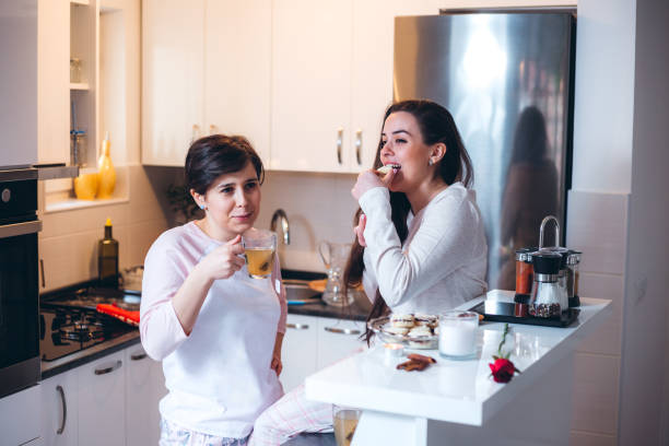 istock Two Roommates Having Tea And Cookies In The Kitchen 1358576204