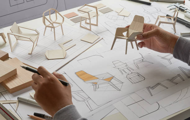 istock Designer sketching drawing design development product plan draft chair armchair Wingback Interior furniture prototype manufacturing production. designer studio concept . 1358576382