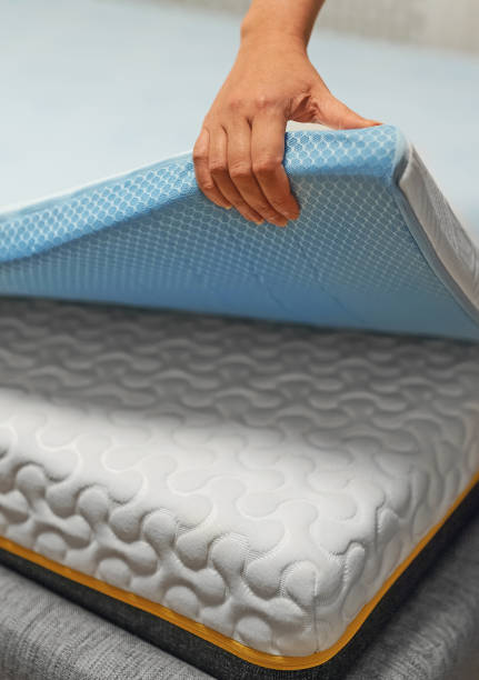 istock Woman hand testing orthopedic memory foam mattress topper. 1358576433