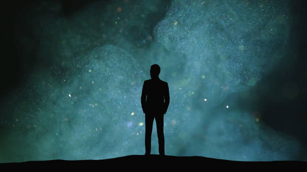 istock The human silhouette standing on a dark cloudy background 1358577166