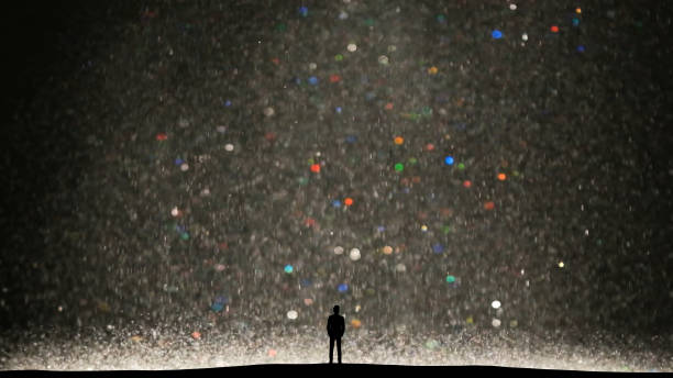 istock The human silhouette standing on a small shiny particles background 1358577191