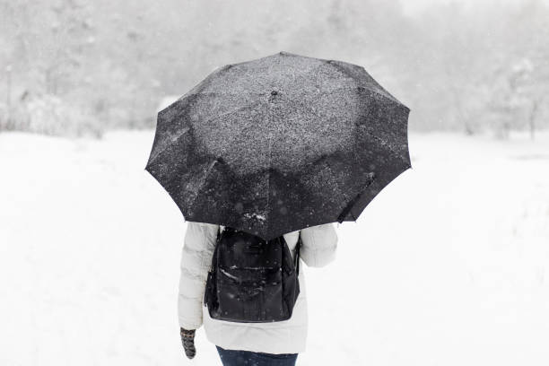 istock A person walks during the snowfall. 1358577199
