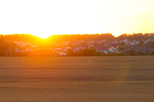 Sunset over the village and the field