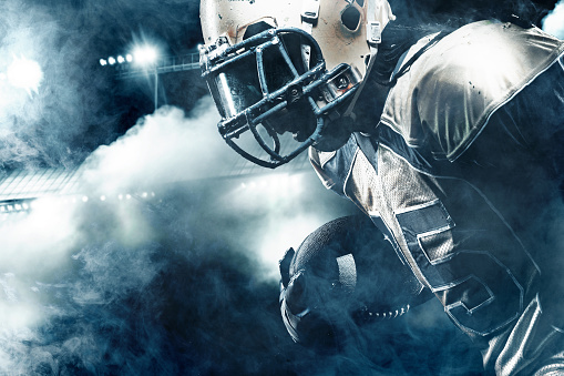 American Football Sportsman Player On Stadium Running In Action Stock Photo  - Download Image Now - iStock