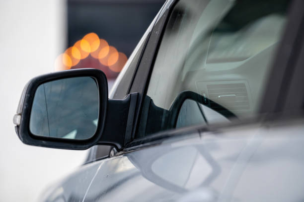 istock side rear-view mirror on a gray shiny car, close-up 1358582237
