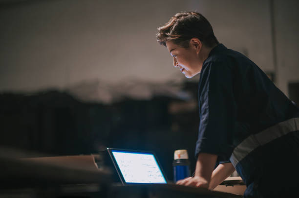 istock Asian Chinese female workshop owner working writing at her workbench desigining work 1358582823
