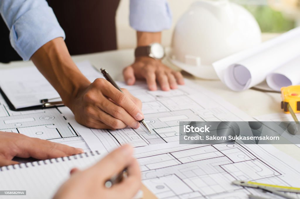 Close-up of an engineer planning a hand-drawn design. with architect equipment Architects talking at the table Teamwork and workflow concepts Architecture Stock Photo