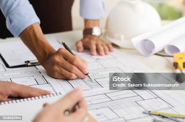 Closeup Of An Engineer Planning A Handdrawn Design With Architect Equipment Architects Talking At The Table Teamwork And Workflow Concepts Stock Photo - Download Image Now