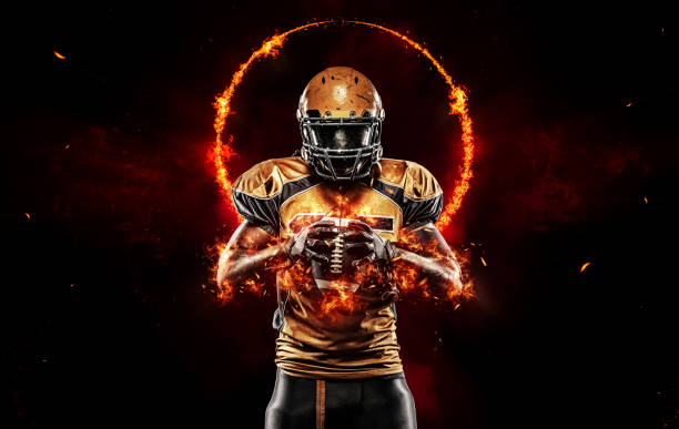 istock American football player black background with fire 1358584243