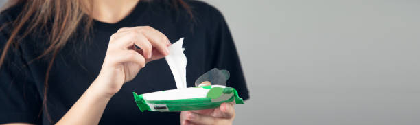 istock woman holding wet wipes from package 1358584308