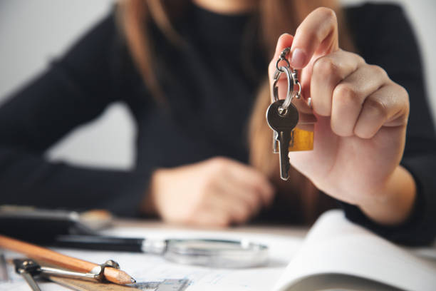 istock Real estate agent holding house key 1358584334