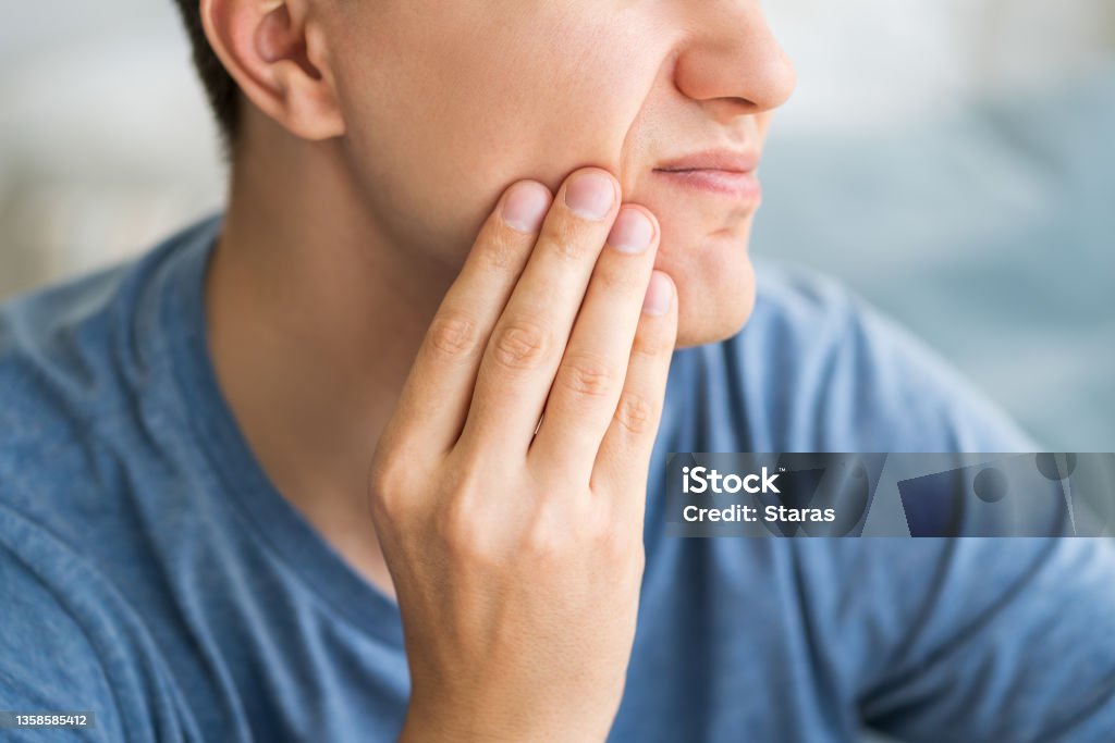 A man with toothache, periodontal disease in wisdom teeth A man with toothache, periodontal disease in wisdom teeth, health problems concept Pain Stock Photo