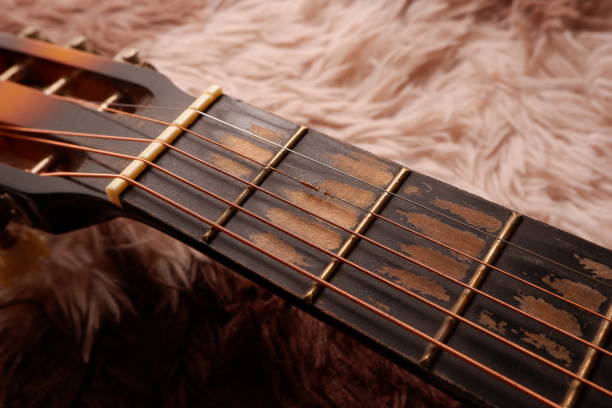 istock Used guitar with broken metal string on a carpet 1358586106