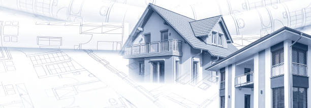 istock Two new houses with blueprints 1358586677
