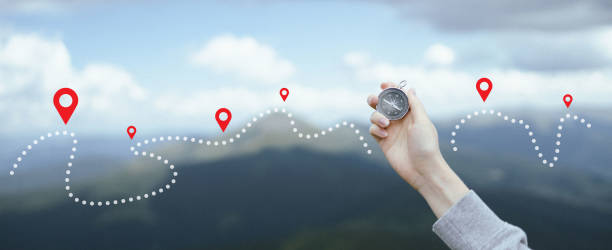 traveler hand holds a compass in the mountains during vacation. horizontal banner with place for text - crossing people panoramic road imagens e fotografias de stock