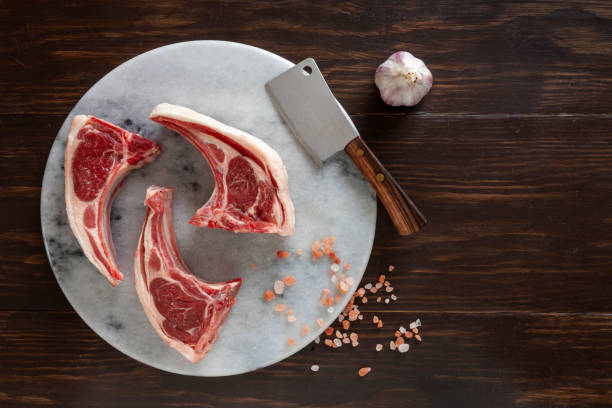istock Fresh raw lamb on ribs on dark wooden background 1358590849