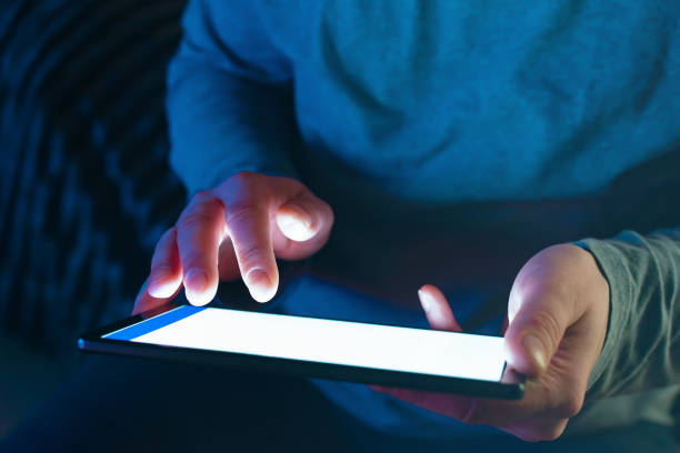 istock A person with a tablet computer in his hands is looking for information on the Internet 1358592066