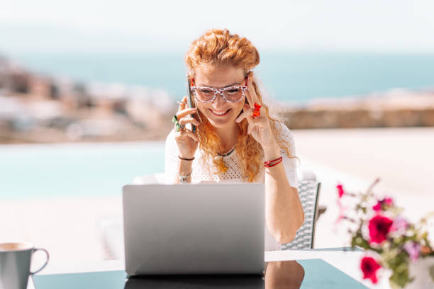 istock Business woman using laptop on terrace 1358592511