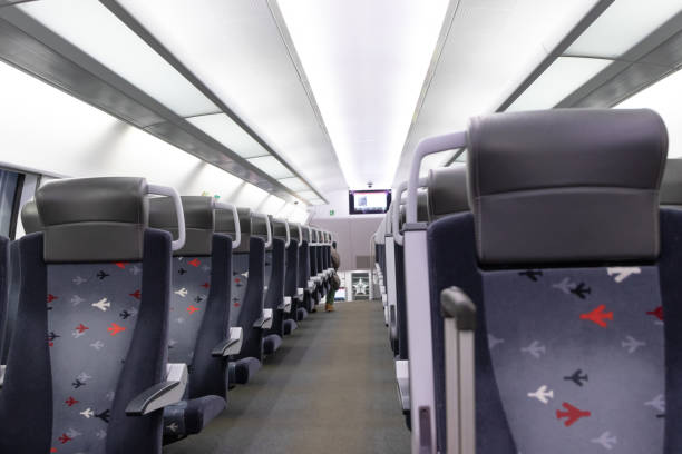 istock An empty cabin of the aeroexpress train without passengers. Soft seats in a row with leather headrests. Public place. Selective focus 1358593330