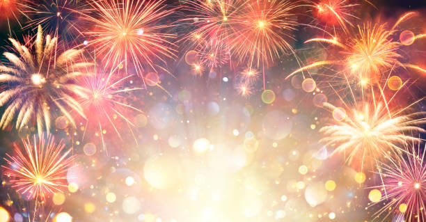 fireworks with golden lights - anniversary celebration in night with abstract defocused bokeh - fireworks stockfoto's en -beelden