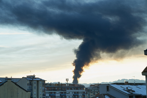 Turin (Italy), December 12, 2021. High column of black smoke caused by the fire of a plastic landfill on the west outskirts of Turin (Beinasco). The incident took place in the plastics recycling company Demap.