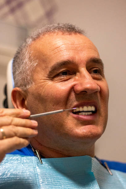 istock Dentist examining a patient's teeth at dental clinic 1358595806