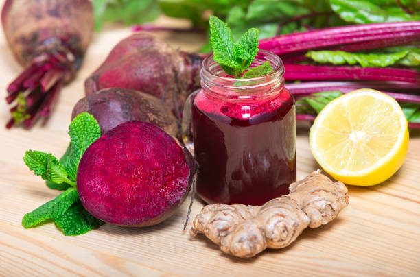 Red Beetroot, ginger and lemon smoothie on wooden Background. homemade detox drinks stock photo