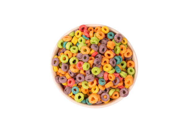 Colorful rings cereal spill out into a bowl. Breakfast. Isolated.