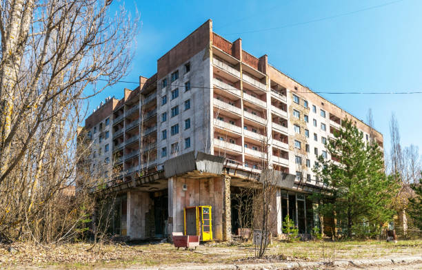 Street of the abandoned ghost town Pripyat. Chernobyl nuclear disaster Prypyat, Chernobyl , Ukraine - April 10, 2021: Abandoned administrative and residential buildings in the ghost town of Pripyat in the Chernobyl exclusion zone in Ukraine. Consequences of radioactive contamination, nuclear disaster at the nuclear reactor of the Chernobyl nuclear power plant pripyat city stock pictures, royalty-free photos & images
