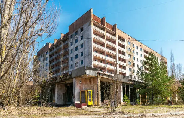 Prypyat, Chernobyl , Ukraine - April 10, 2021: Abandoned administrative and residential buildings in the ghost town of Pripyat in the Chernobyl exclusion zone in Ukraine. Consequences of radioactive contamination, nuclear disaster at the nuclear reactor of the Chernobyl nuclear power plant
