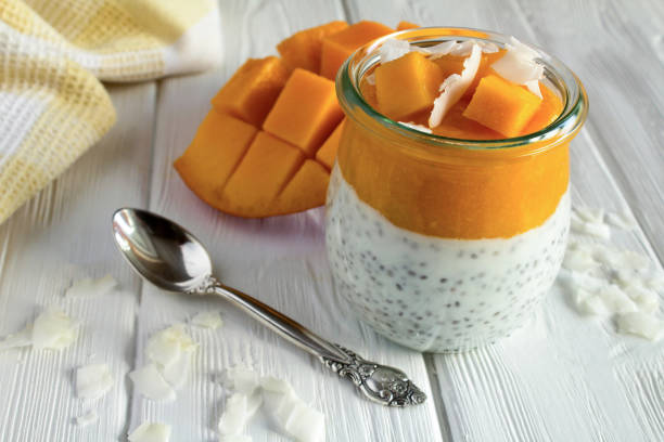 istock Pudding with chia seed, mango and coconut chip on the  white wooden background. Close-up. 1358603763