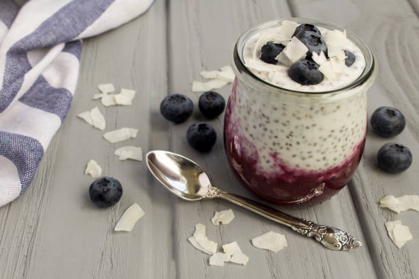 istock Pudding with chia seed, blueberry  and coconut chips on the gray background. Close-up. 1358603773