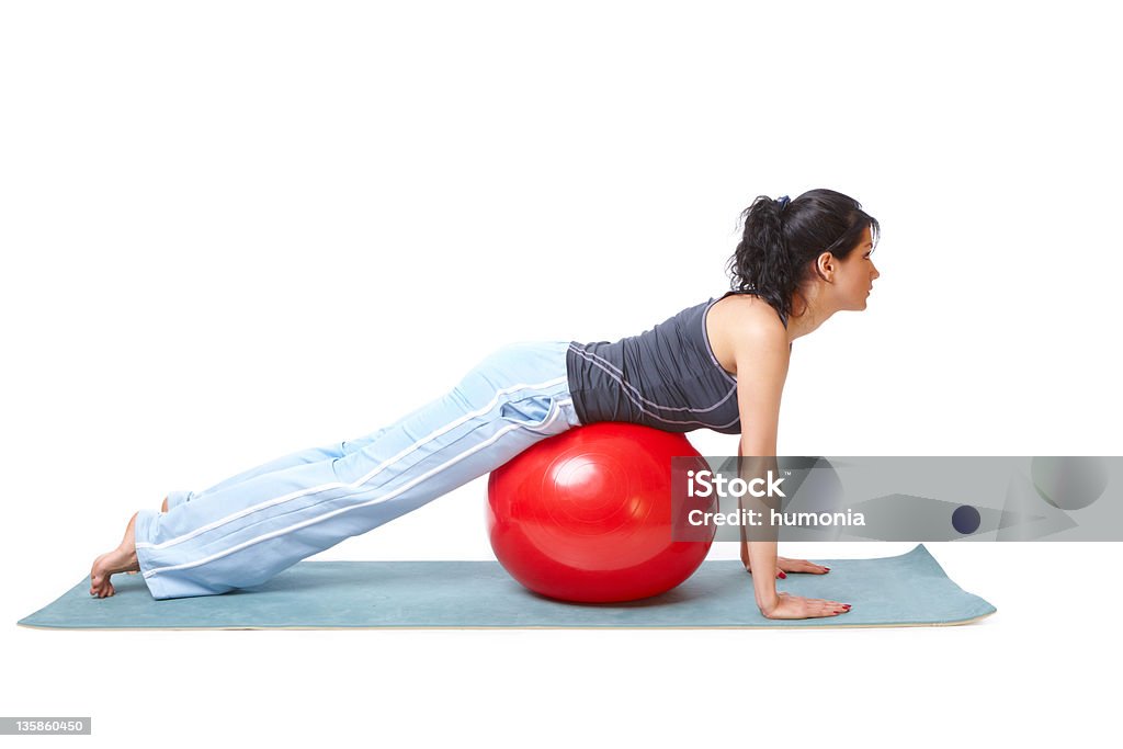 Woman with gym ball Beautiful young woman with gym ball exercising, isolated on white background Active Lifestyle Stock Photo