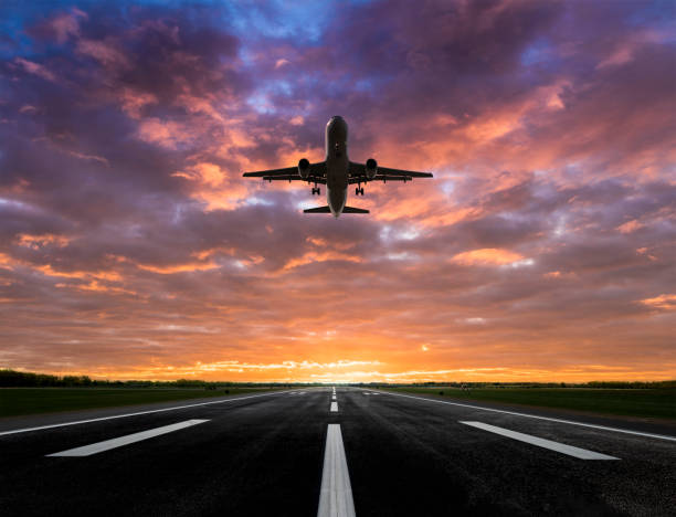 istock Passenger airplane taking off at sunset 1358605069